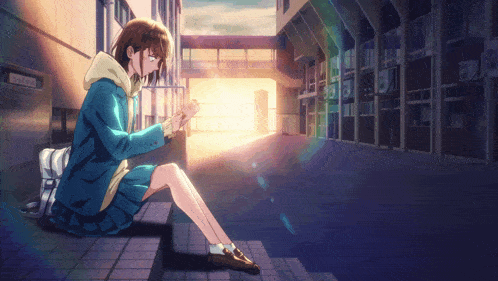 a girl in a blue jacket sits on a set of steps looking at her phone