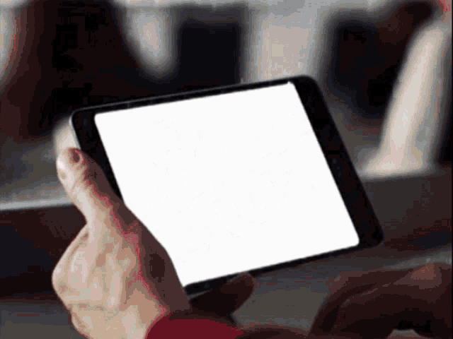a person holding a tablet with a blank screen