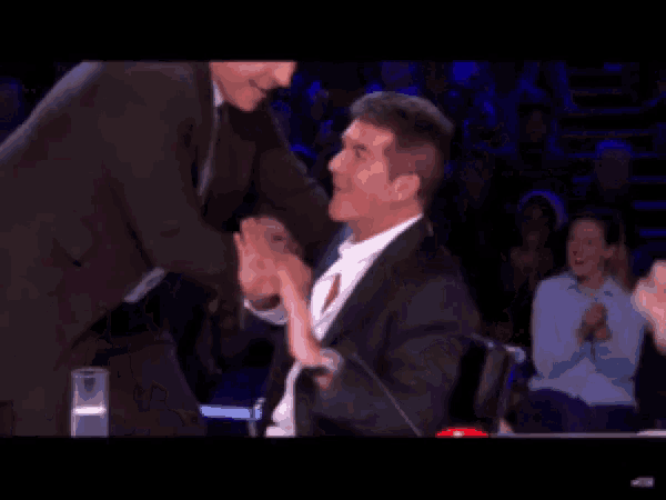 a man in a suit is standing next to another man in a suit