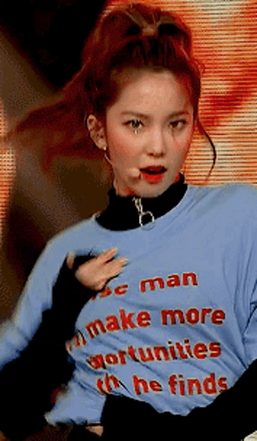 a woman wearing a blue shirt that says ' make more opportunities he finds '