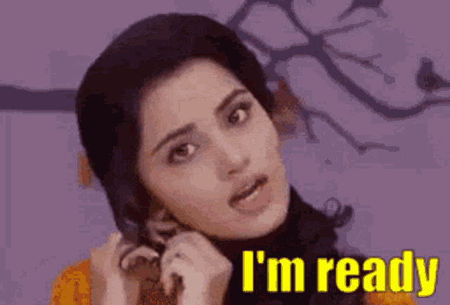 a woman is talking on a cell phone and the words `` i 'm ready '' are written above her .