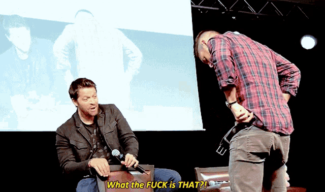 a man talking into a microphone with the words what the fuck is that
