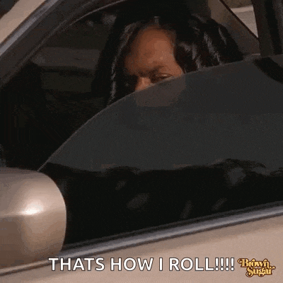 a woman is sitting in the driver 's seat of a car and looking out the window .