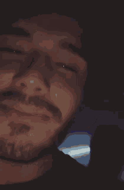 a close up of a man with his eyes closed .