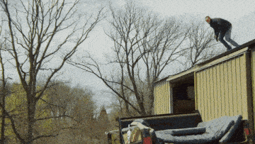 a man is standing on the roof of a truck