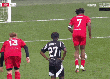 a soccer player wearing a number 27 jersey stands on the field