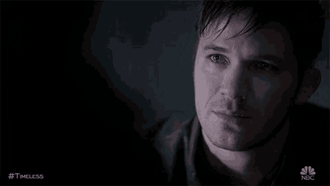 a close up of a man 's face with tears running down his face in a dark room .