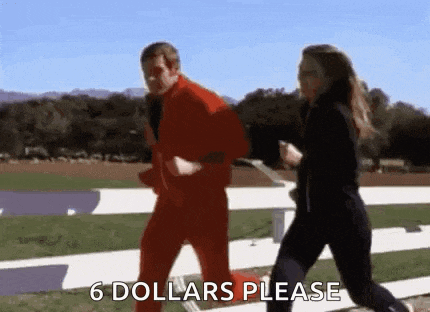 a man and a woman are running on a track and the man is wearing a red suit and the woman is wearing black pants .