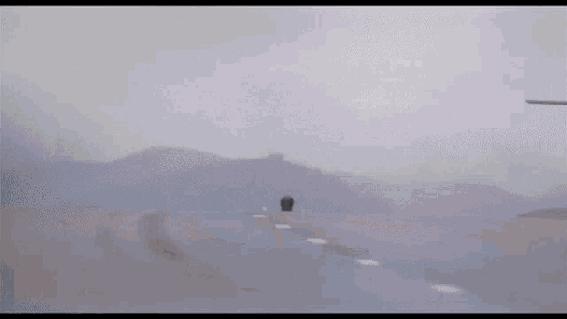 a man wearing a helmet is riding a motorcycle on a highway