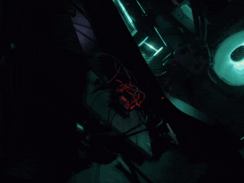 a bunch of wires are connected to a board and one of them has a purple light coming out of it