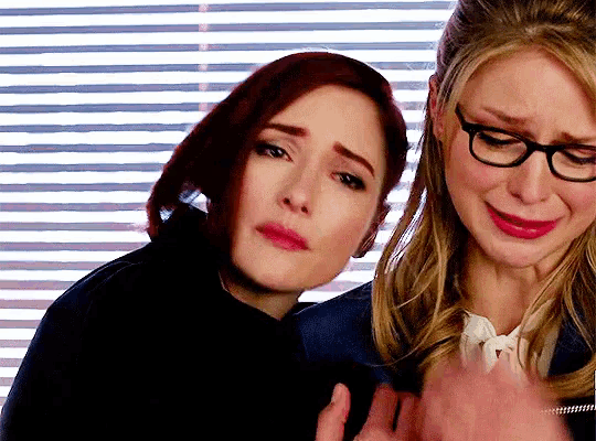 two women standing next to each other one is crying