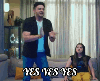 a man and a girl are sitting on a couch and the man is saying yes yes yes .