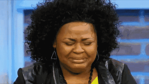 a woman with curly hair is making a funny face