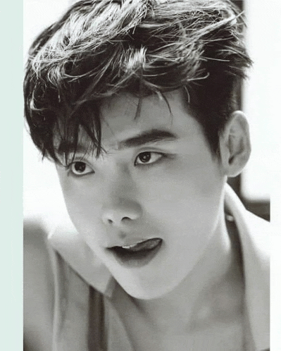 a close up of a young man 's face with his tongue out in a black and white photo .