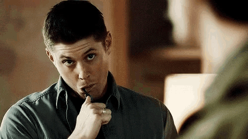 a man with a pen in his mouth and a ring on his finger