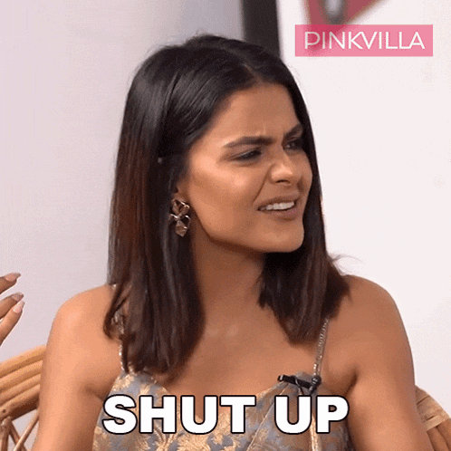 a woman is sitting in a chair with the words shut up written on her face