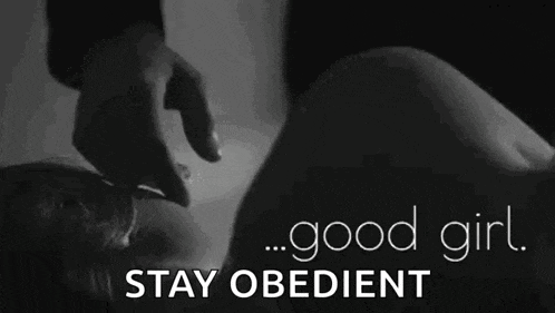 a man is touching a woman 's face in a black and white photo with the words `` good girl stay obedient '' .