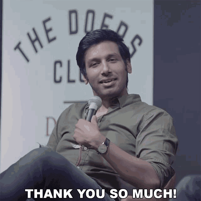 a man sitting in front of a microphone with the words thank you so much below him