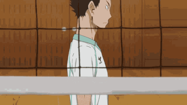 a volleyball player in a white shirt with the word adidas on it
