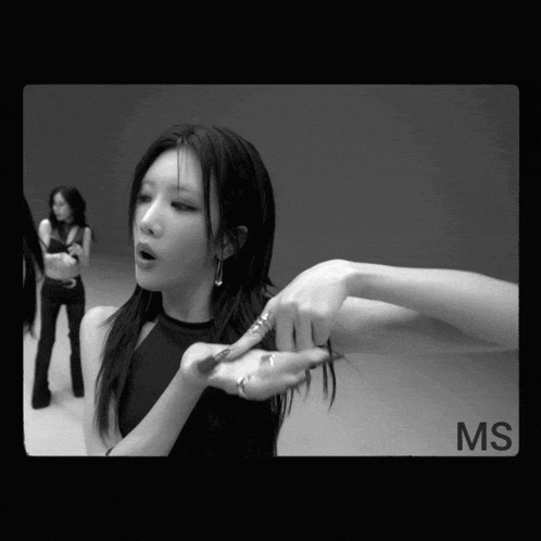 a black and white photo of a woman with the word ms on the bottom right