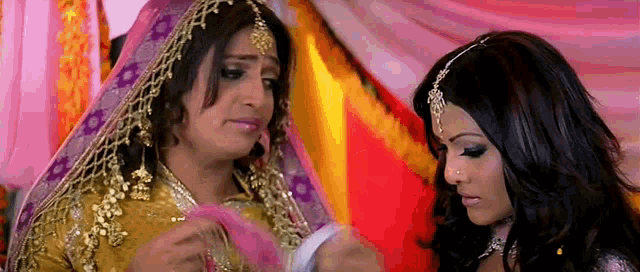 a man dressed as a bride is talking to a woman dressed as a bride .