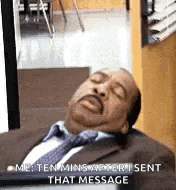 a man in a suit and tie is sleeping in a room with his eyes closed .