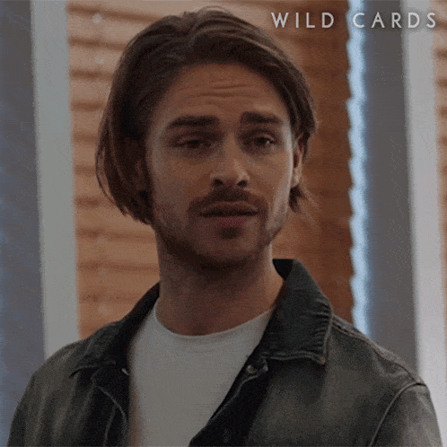 a close up of a man 's face with the words wild cards written above him