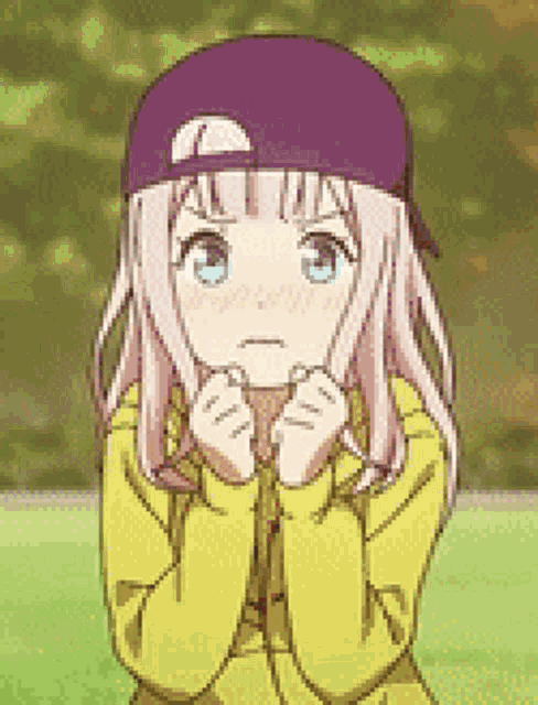 a girl wearing a purple hat and a yellow jacket is making a sad face .