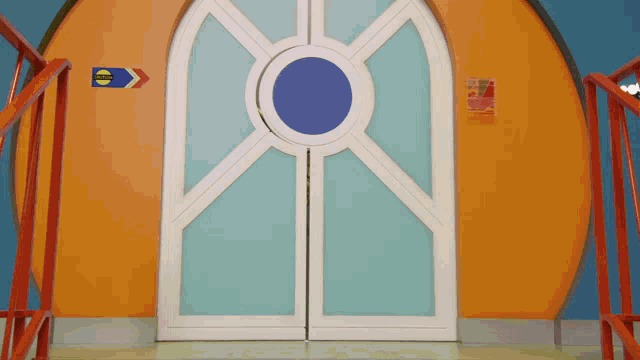 a door with a blue circle in the middle and a blue arrow pointing to the right
