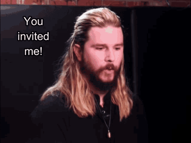a man with long hair and a beard says " you invited me "