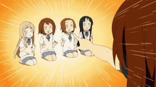 a group of anime girls are kneeling down and one girl is pointing