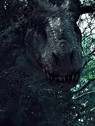 a close up of a dinosaur 's face in a forest .