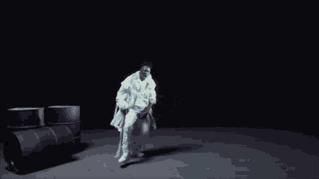 a person is crawling on a wall next to a toilet .