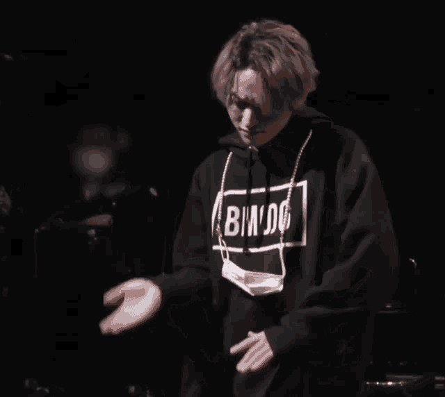 a man wearing a hoodie that says bmdg on it
