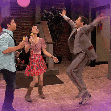 a man in a suit is jumping in the air while a woman holds a banana in her hand