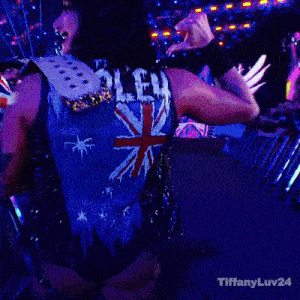 a woman is wearing a blue vest with a british flag on the back