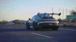 a car is driving down a highway with a green sign in the background .