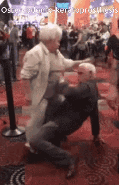 an older couple dancing in a crowd with the caption osteo-odonto-keratoprothesis