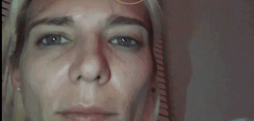 a close up of a woman 's face with a sad look on her face