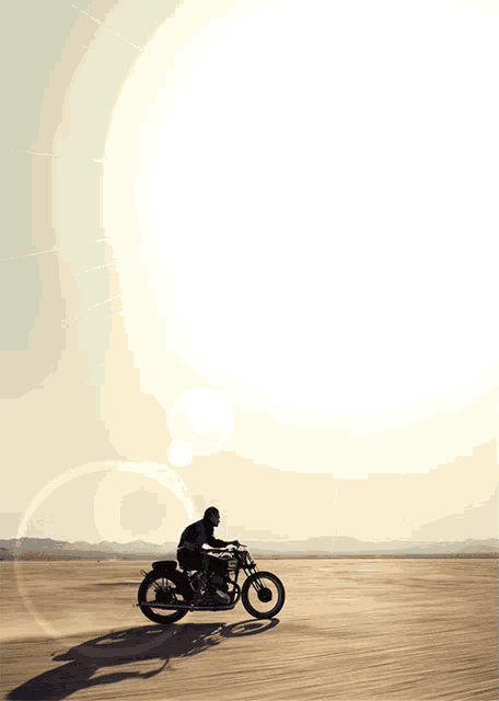 a man riding a motorcycle in the desert
