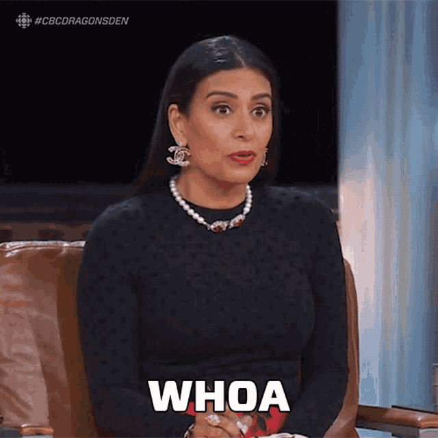 a woman sitting in a chair with the word whoa written on her chest