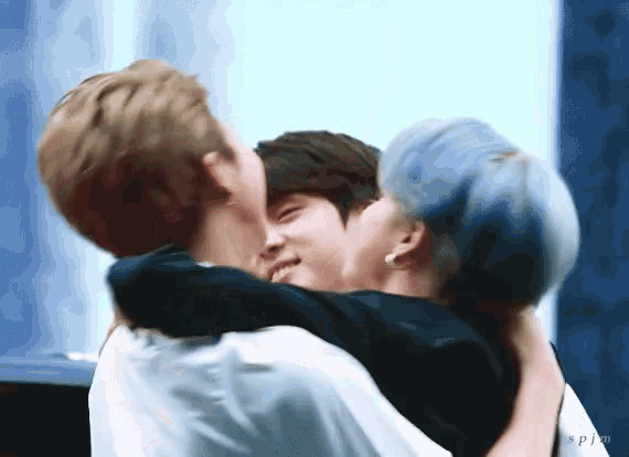 a group of young men hugging each other with the letters sp on the bottom right