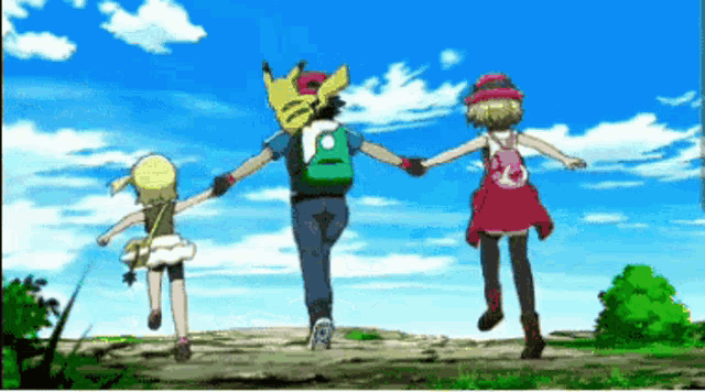 a man and two girls are holding hands while walking on a path
