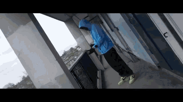 a person wearing a blue jacket and neon yellow nike shoes