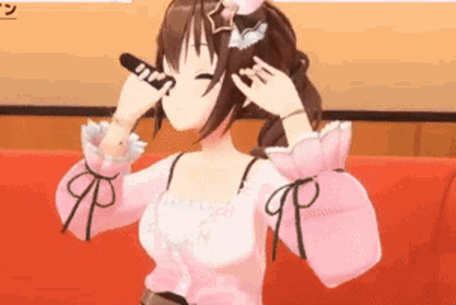 a girl in a pink dress is sitting on a red couch with her eyes closed .