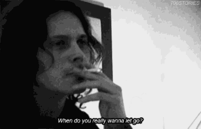 a man smoking a cigarette with the words when do you really wanna let go below him