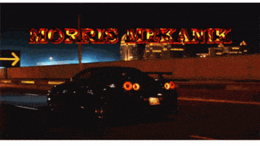 a black car is driving down a highway at night with the words morris mekanik written above it