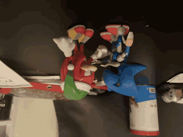 sonic the hedgehog and knuckles are sitting on a table