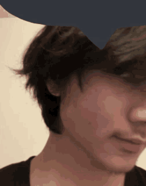 a close up of a person 's face with a blue circle in the background