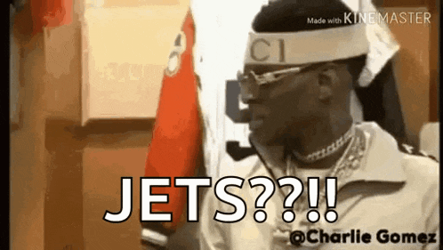 a man wearing a headband that says jets is standing in a room .